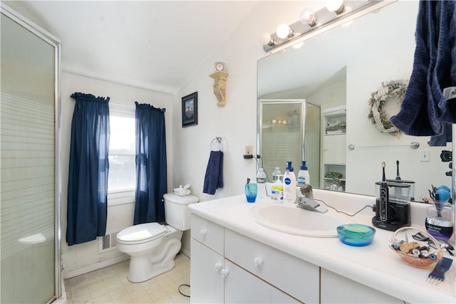 bathroom featuring vanity, toilet, a shower stall, and vaulted ceiling