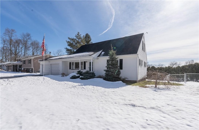 view of front of property featuring fence and a garage