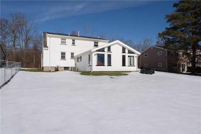 rear view of house featuring fence