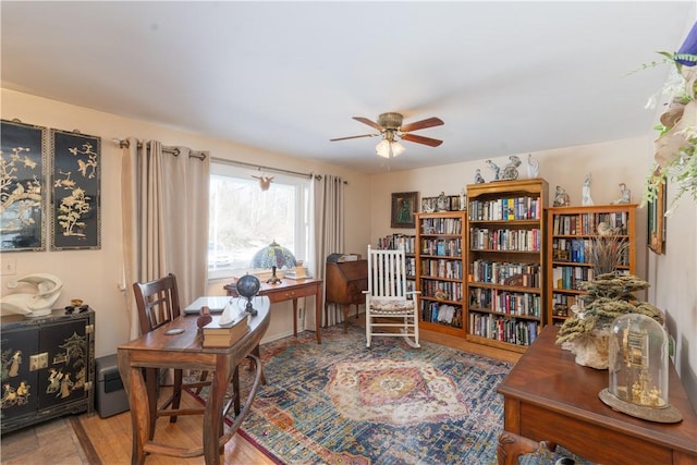 home office with wood finished floors and ceiling fan