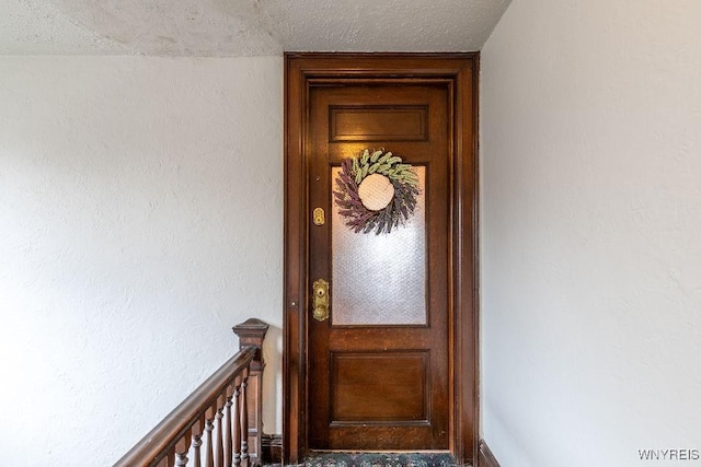 entrance to property with stucco siding