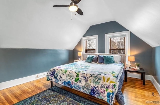 bedroom featuring ceiling fan, baseboards, lofted ceiling, and wood finished floors