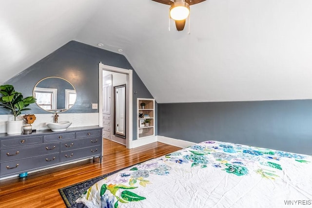 bedroom featuring ceiling fan, lofted ceiling, and wood finished floors