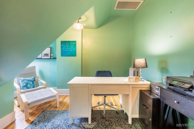 home office featuring visible vents and wood finished floors