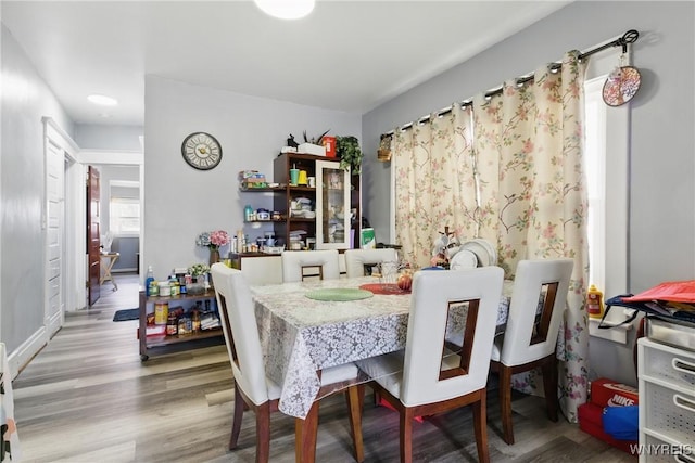 dining space with wood finished floors