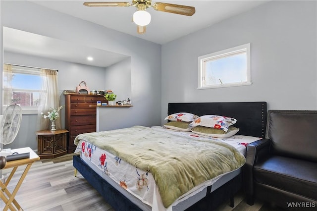 bedroom with a ceiling fan and wood finished floors