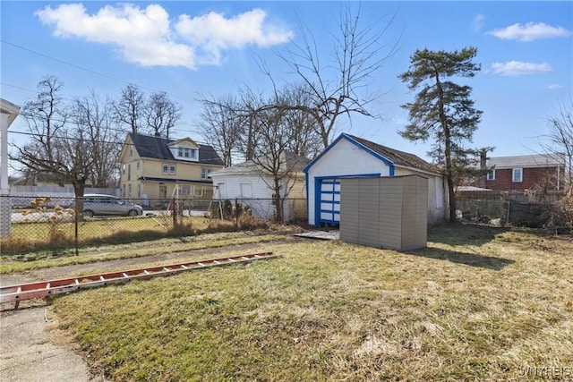 view of yard with an outbuilding, a fenced backyard, and a shed