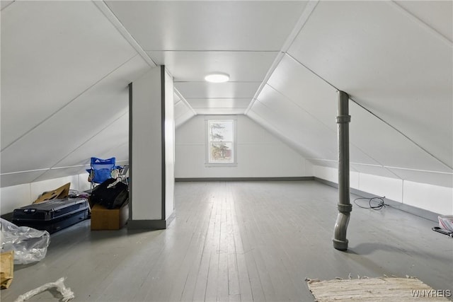 bonus room with hardwood / wood-style floors and lofted ceiling