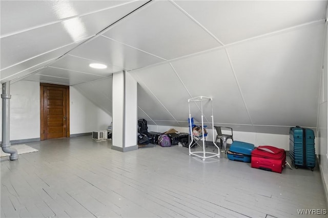 bonus room with vaulted ceiling and wood finished floors