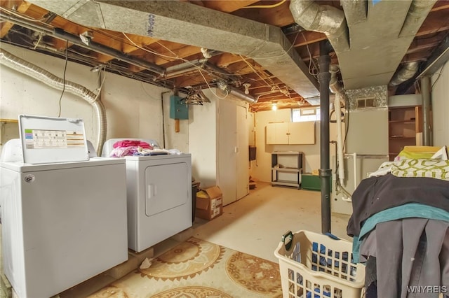 below grade area with electric panel and washing machine and clothes dryer