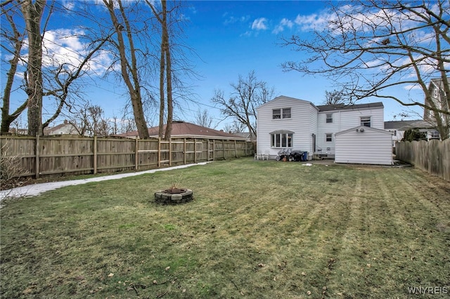 view of yard with a fenced backyard and an outdoor fire pit