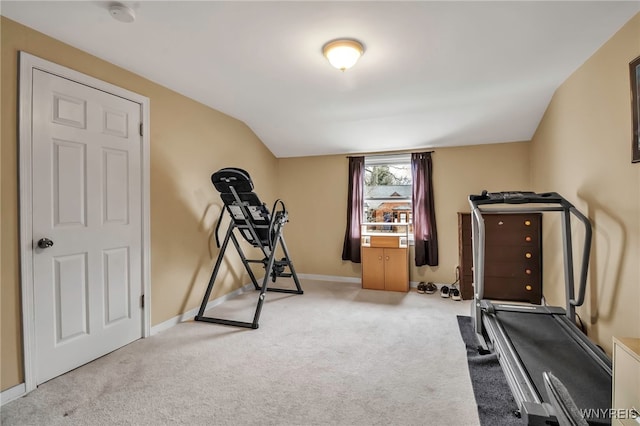 exercise room with baseboards and carpet