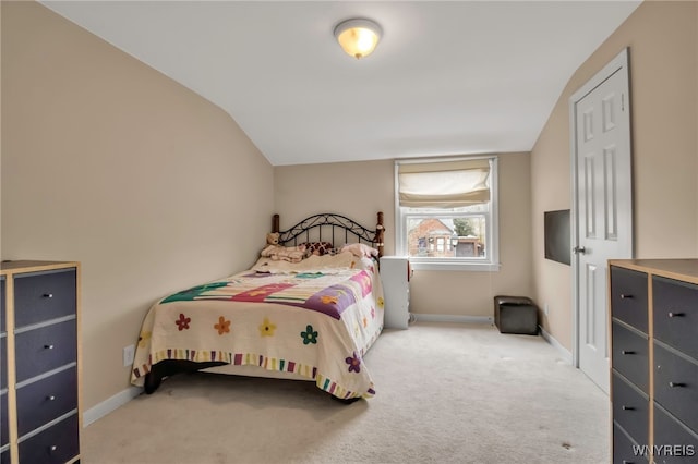 bedroom with vaulted ceiling, carpet, and baseboards