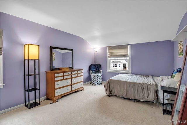 bedroom featuring baseboards, carpet floors, and vaulted ceiling