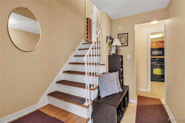 stairway featuring tile patterned flooring and baseboards