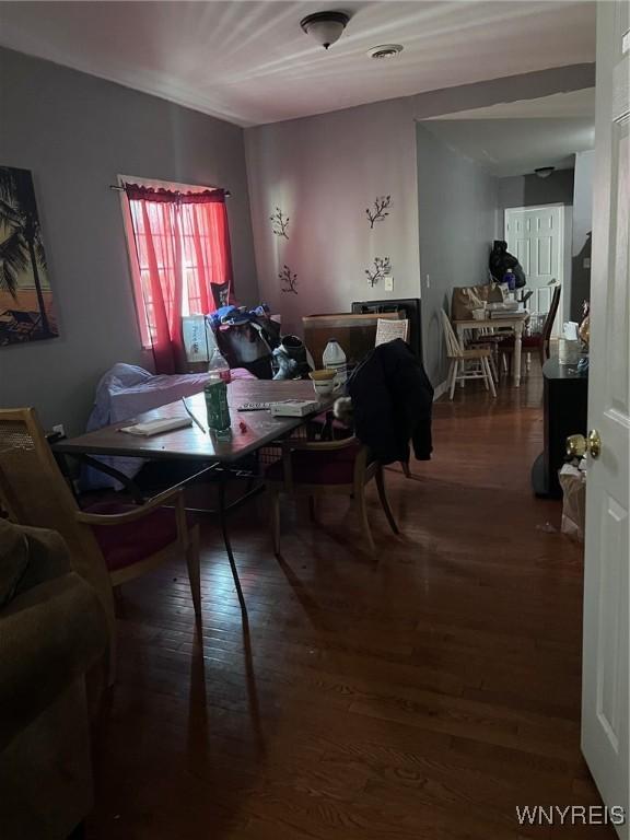 dining space with visible vents and wood finished floors