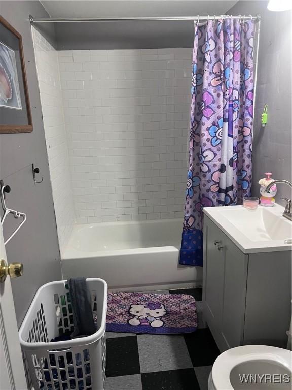 full bath featuring vanity, tile patterned floors, toilet, and shower / bathtub combination with curtain