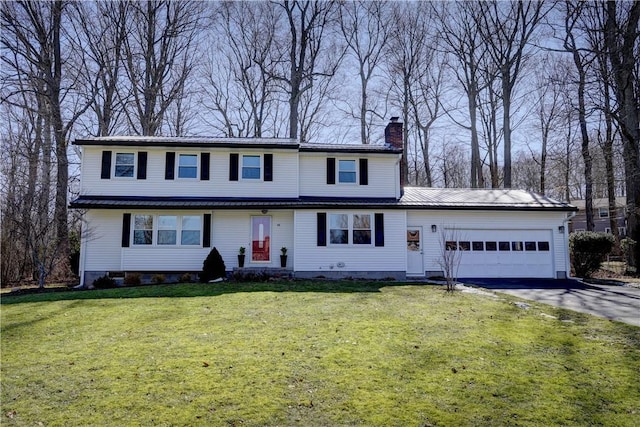 traditional home with a front lawn, aphalt driveway, a chimney, metal roof, and an attached garage