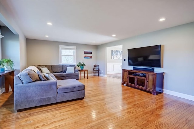 living area with recessed lighting, baseboards, and light wood finished floors