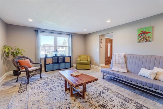 living room with recessed lighting, light wood-type flooring, and baseboards