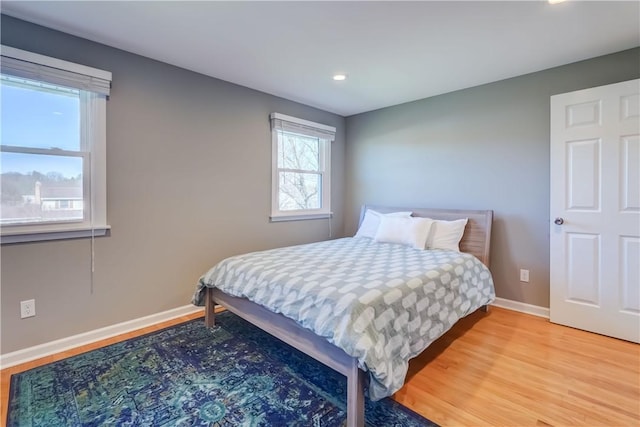 bedroom with baseboards and light wood-style floors