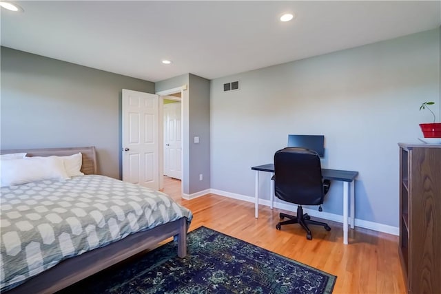 bedroom featuring recessed lighting, baseboards, and light wood-type flooring