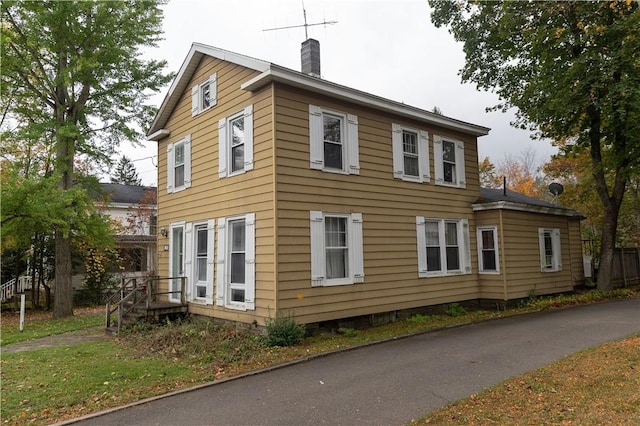 view of home's exterior featuring a chimney