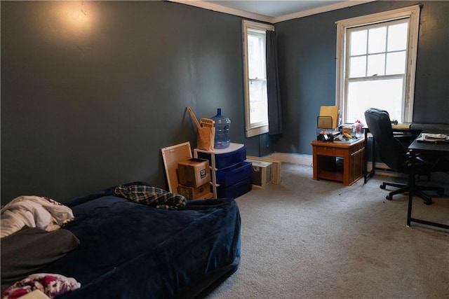 bedroom with carpet flooring, crown molding, and baseboards