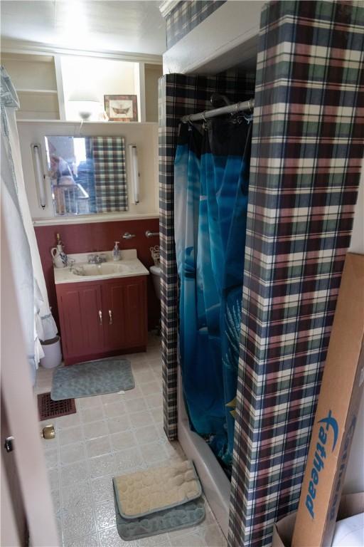 bathroom with a shower stall and vanity