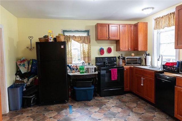 kitchen with a toaster, black appliances, and a sink