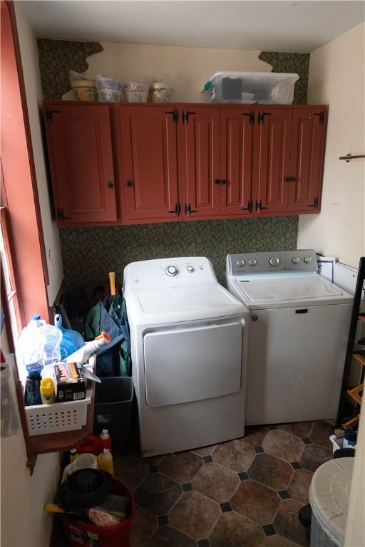 washroom featuring cabinet space and independent washer and dryer