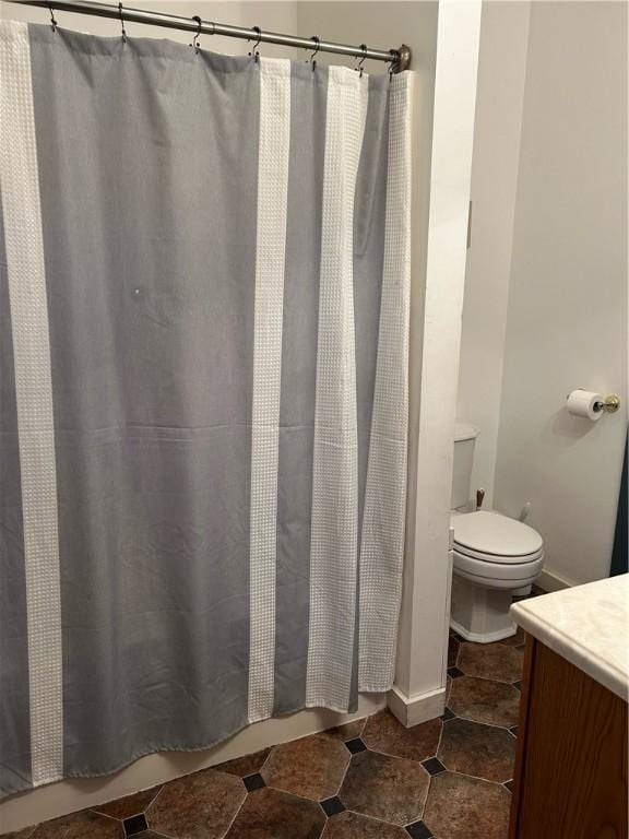 bathroom with vanity, toilet, and a shower with curtain