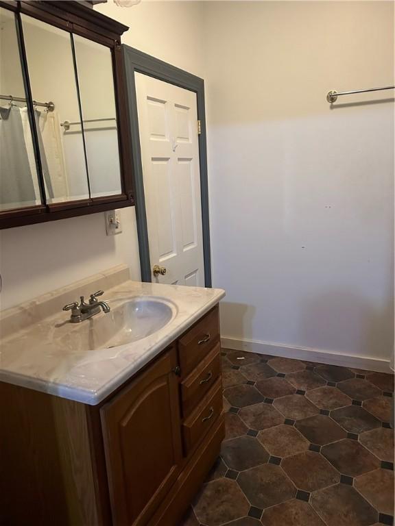 bathroom featuring baseboards and vanity