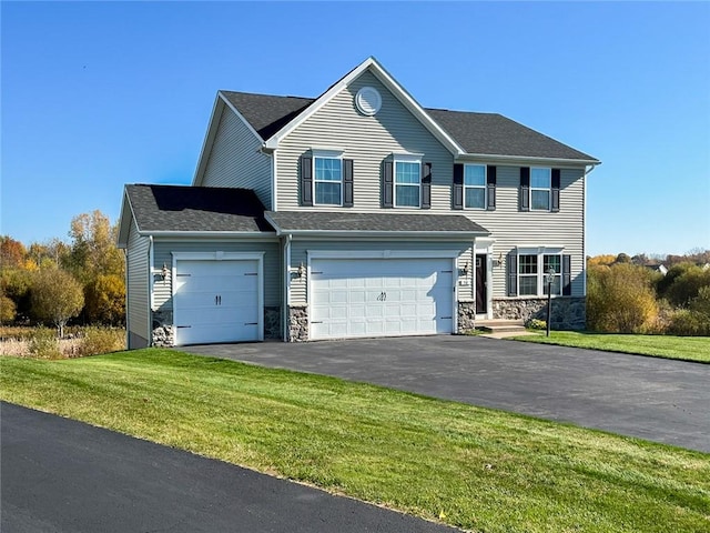 view of front of house featuring stone siding, a garage, driveway, and a front yard