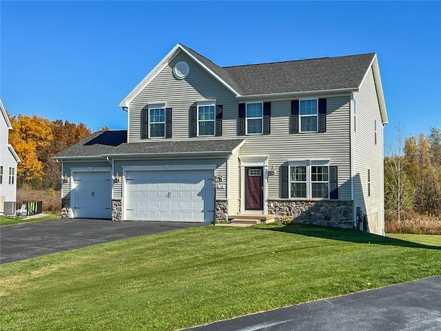 view of front of home with driveway, an attached garage, a shingled roof, a front lawn, and stone siding