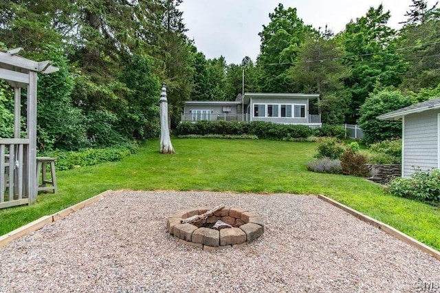 view of yard with an outdoor fire pit