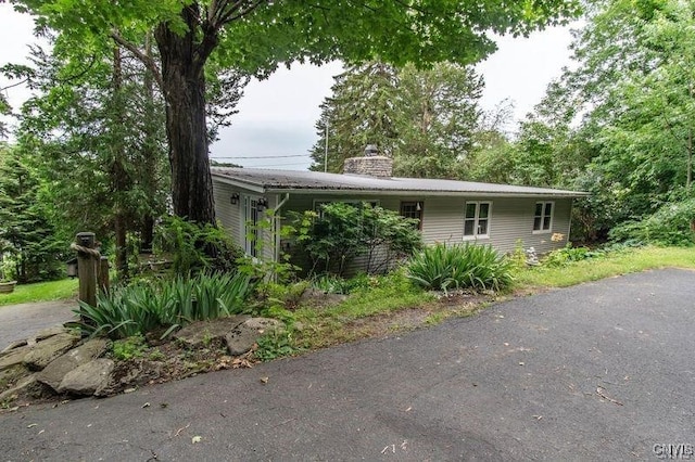 view of front of home featuring a chimney