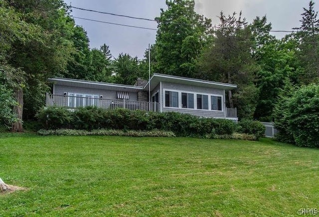 rear view of house featuring a yard