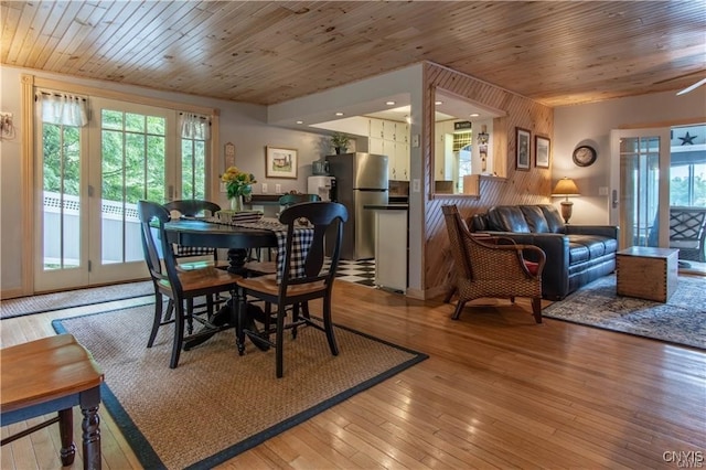 dining space featuring wooden ceiling, light wood-style floors, and a healthy amount of sunlight