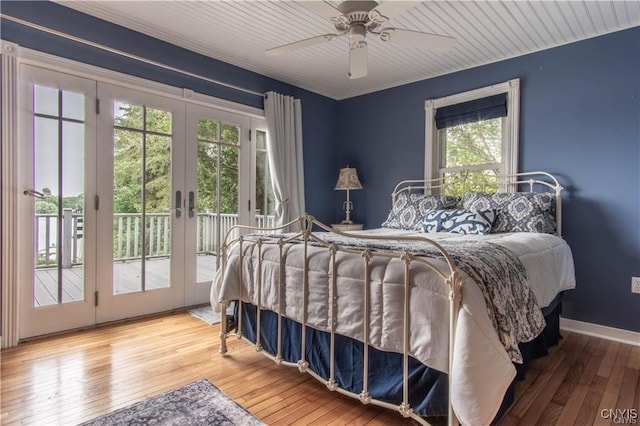 bedroom with access to exterior, ceiling fan, baseboards, and wood-type flooring