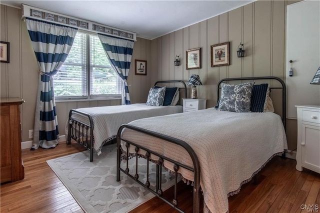 bedroom featuring baseboards and wood-type flooring