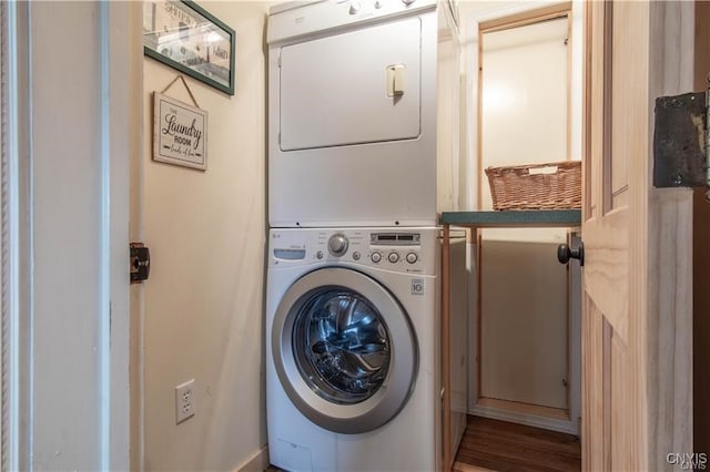 laundry area with stacked washing maching and dryer