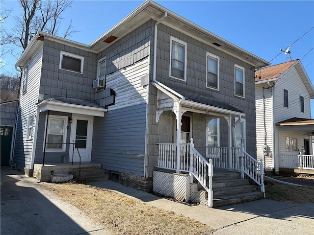 view of front of property featuring a porch and cooling unit