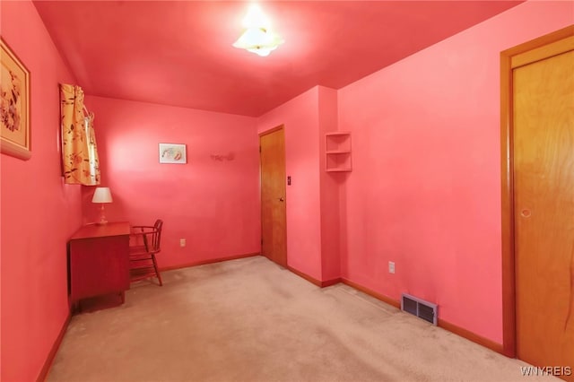 office space featuring carpet flooring, baseboards, and visible vents