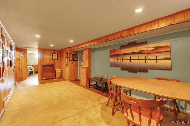 dining area with recessed lighting and wood walls