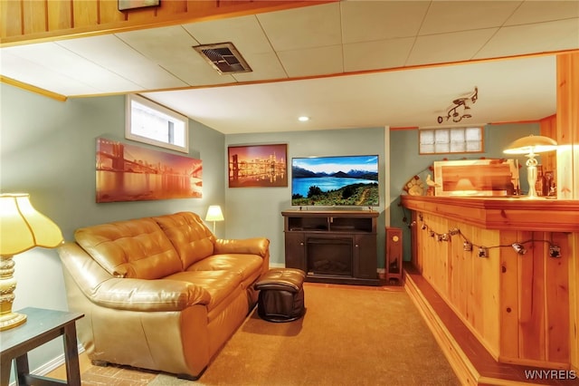 carpeted living room with visible vents and a fireplace