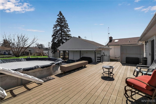 wooden deck featuring a covered pool