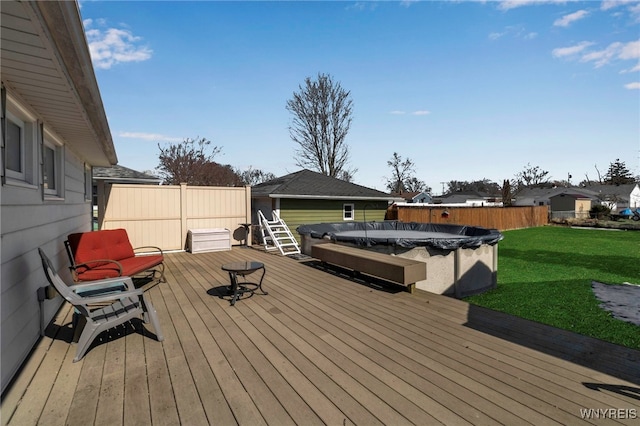 wooden terrace with a fenced in pool, fence, and a lawn