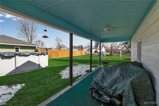 view of patio / terrace with a covered pool and fence