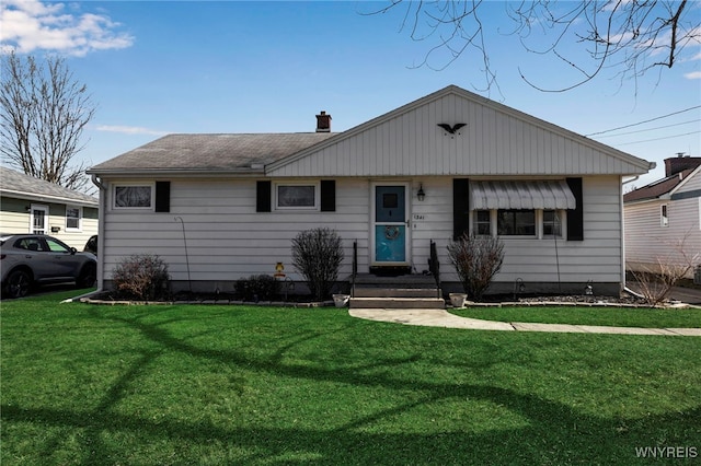 single story home featuring roof with shingles and a front lawn